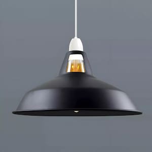 May include: Black pendant light with a metal shade and a white cord. The light is hanging from a ceiling.