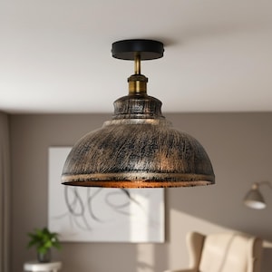 May include: An industrial-style ceiling light with a distressed bronze finish. The dome-shaped shade has a black and bronze colour scheme. The fixture includes a black mounting plate and brass-coloured accents.
