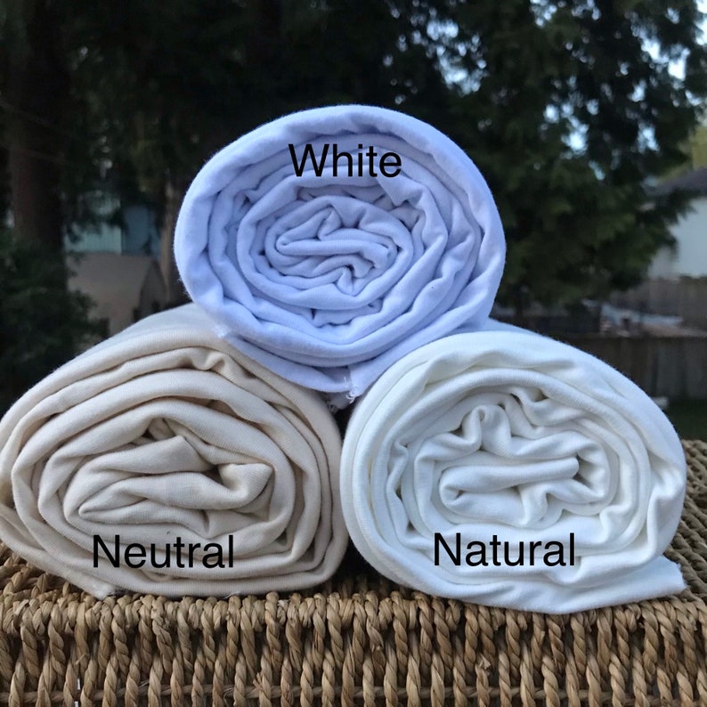 May include: Three rolled up fabric swatches in white, natural, and neutral colors. The swatches are labeled "White", "Natural", and "Neutral".