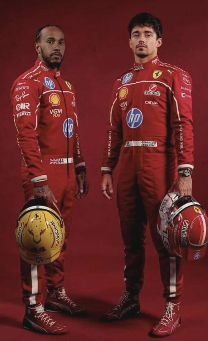 May include: Two individuals in red racing suits, each holding a helmet. One helmet is yellow with a black design, the other is red with white accents. The suits feature sponsor logos and the HP logo.