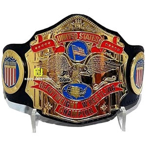 May include: A gold and black wrestling championship belt with a red, white, and blue American flag design. The belt features the words "United States Heavyweight Wrestling Champion" and an eagle with its wings spread.