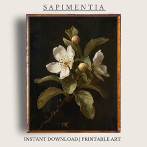 Puede incluir: Impresión floral enmarcada con flores blancas y hojas verdes sobre un fondo oscuro. La obra incluye el texto "SAPIMENTIA" en la parte superior y "INSTANT DOWNLOAD | PRINTABLE ART" en la inferior. El marco tiene un acabado dorado.