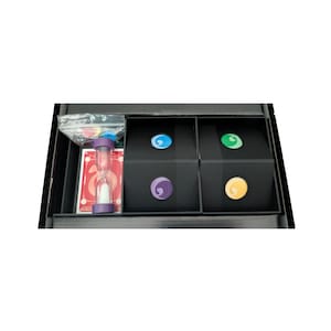 May include: A board game set inside a black box containing a purple hourglass, a deck of cards with red backs, and four small black boxes. Each black box features a circular sticker in blue, green, purple, or yellow with a white swirl graphic.