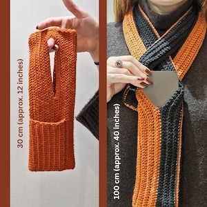 May include: An orange knitted phone sleeve, approximately 12 inches long, with a pocket. A matching scarf, about 40 inches long, is black and orange. The items are handmade and suitable for cold weather.