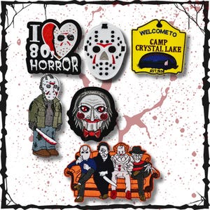 May include: A collection of horror-themed embroidered patches. The patches feature iconic characters and imagery from classic horror films, including Jason Voorhees, Pennywise, and Freddy Krueger. The patches are in various shapes and sizes, with vibrant colors and detailed designs.