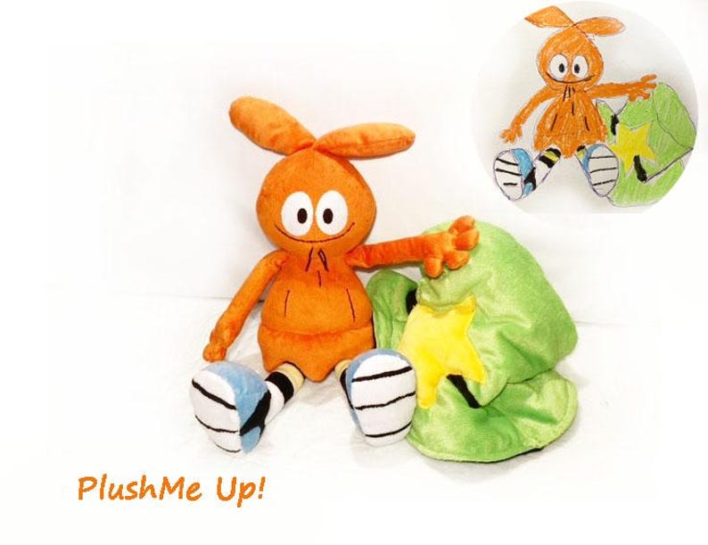 May include: An orange plush toy with big eyes, long ears, and outstretched arms, next to a green hat with a yellow star. The toy has blue and white striped shoes. The text "PlushMe Up!" is in the bottom left corner.