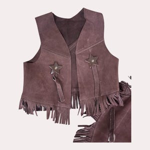 May include: A brown suede vest with fringe and star-shaped embellishments. The vest is part of a cowboy costume.