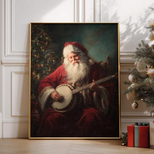 May include: A framed painting of Santa Claus playing a banjo. Santa is wearing a red suit and hat with a long white beard. The painting has a gold frame and is set against a teal background. A Christmas tree is in the background.