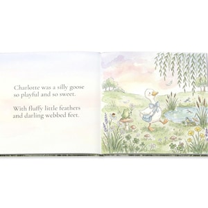 May include: An open book with watercolor illustrations. The left page has text: "Charlotte was a silly goose so playful and so sweet. With fluffy little feathers and darling webbed feet." The right page shows a goose with a blue bag.