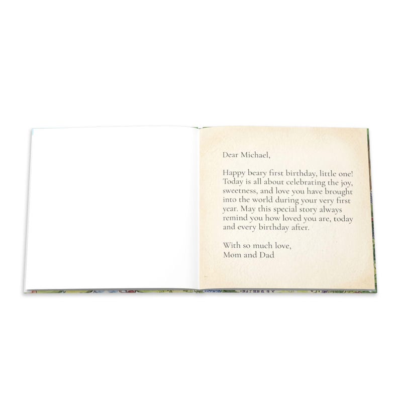 May include: An open book with a blank white left page and a right page featuring a printed message that reads: Dear Michael, Happy beary first birthday, little one! Today is all about celebrating the joy, sweetness, and love you have brought into the world during your very first year. May this special story always remind you how loved you are, today and every birthday after. With so much love, Mom and Dad.