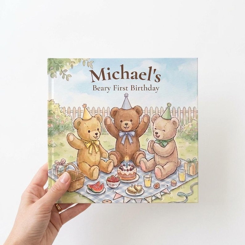 May include: A square hardcover book titled Michael's Beary First Birthday featuring a watercolor illustration of three teddy bears wearing party hats on a blue and white checkered picnic blanket with a birthday cake, gifts, and snacks.