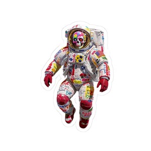 May include: A sticker of an astronaut in a white spacesuit covered in colorful graffiti. The astronaut's helmet has a rainbow design and a skull face. The spacesuit has red gloves and boots, with the American flag on the shoulder.