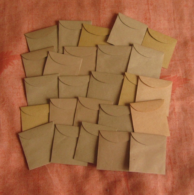 May include: A collection of brown paper envelopes, stacked and arranged in a staggered pattern. The envelopes are all the same size and shape, and they have a slightly textured surface.