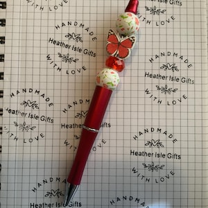 Stylo perlé rouge papillon et fleurs