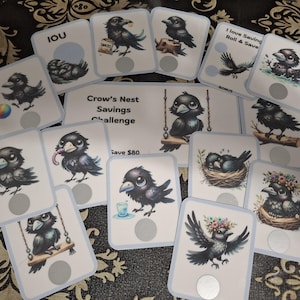 May include: A collection of rectangular cards and a larger central card featuring the text Crow's Nest Savings Challenge and Save $80. Each card displays a cartoon crow illustration with various items like snacks, a ball, or flowers, and includes a circular gray scratch-off area.