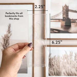 May include: A clear acrylic bookmark holder, 6.25 inches tall and 2.25 inches wide.  The holder is designed to fit all bookmarks from this shop.