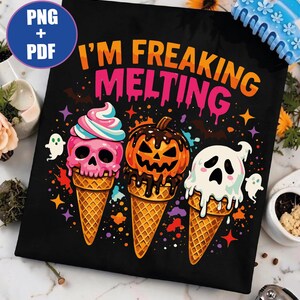 May include: A black graphic print featuring the text I'M FREAKING MELTING in orange and pink. The design includes three ice cream cones: one with a pink skull, one with an orange jack-o'-lantern, and one with a white ghost, surrounded by stars.