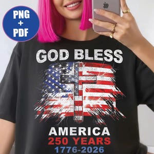 May include: A black t-shirt featuring a graphic of a distressed American flag with a central cross. The text reads GOD BLESS AMERICA 250 YEARS 1776-2026. The design includes white and red lettering and a blue circle icon in the corner labeled PNG + PDF.