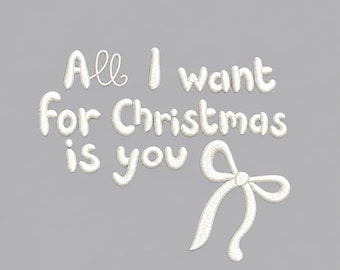 May include: White machine embroidery design featuring the text All I want for Christmas is you in a rounded, bubbly font. Below the text is a simple, elegant white ribbon bow. The design has a textured, stitched appearance on a gray background.