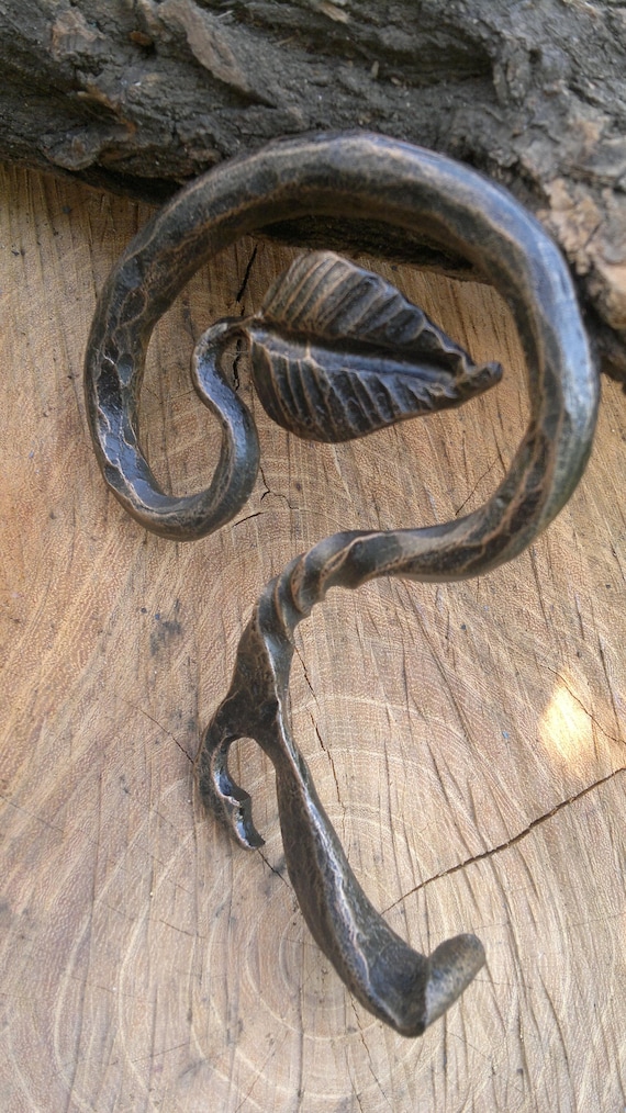 Heavy, rustic, blacksmith-forged iron bottle opener — the kind of barware that outlives you.