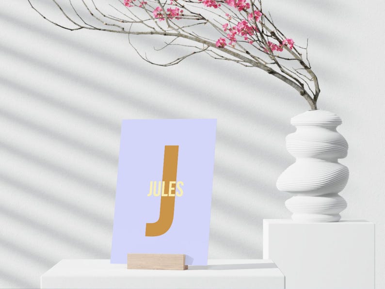 May include: A light blue card with a large brown letter "J" and the word "JULES" in yellow text.