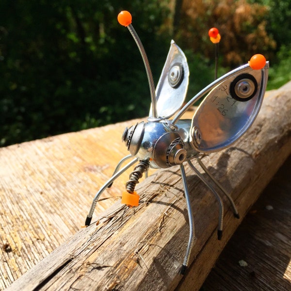 Scrap Metal Bug, Creature, Mixed Media Art, Recycled materials, with UV orange and black rubber