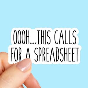 May include: A white sticker with black text that reads "OOOH...THIS CALLS FOR A SPREADSHEET" is held against a light blue background. The sticker has a black border and is held by a person's hand.