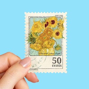 May include: A postage stamp featuring Vincent van Gogh's "Sunflowers" painting. The stamp has a light blue background with a rectangular frame and a 50 cents denomination. The stamp is held by a hand.