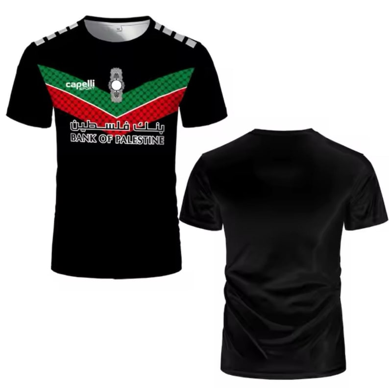 May include: Black short-sleeved t-shirt with a red, white, and green design. The shirt has the text "Bank of Palestine" and "capelli" on it.
