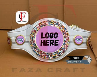May include: A white championship belt featuring a large circular centre plate with a pink background and the text "LOGO HERE" in black. The plate is bordered by a ring of miniature international flags. Two smaller circular side plates read "CUSTOM LOGO".