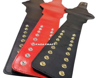 May include: Three leather wrist cuffs in black and red, each with metal snap closures. The cuffs are arranged diagonally, showcasing the contrasting colours and the "FAZA CRAFT" text.