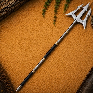 May include: A long metal trident featuring a three-pronged silver head, a slender shaft with alternating black and silver segments, and gold-colored rings at the joints. The base of the shaft terminates in a pointed metal tip, creating a balanced design.