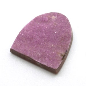 May include: A pink, irregularly shaped, semi-precious gemstone with a rough, textured surface.