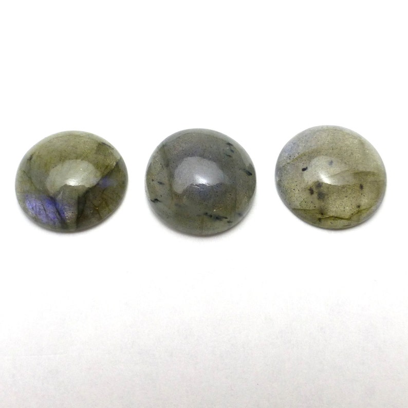 May include: Three round, smooth, green labradorite cabochons with iridescent blue and black flecks.