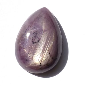 May include: A teardrop-shaped purple gemstone with a star-like pattern.