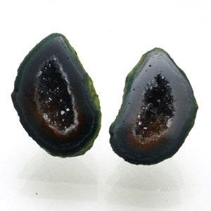 May include: Two green and black agate geode halves with a clear quartz crystal interior.