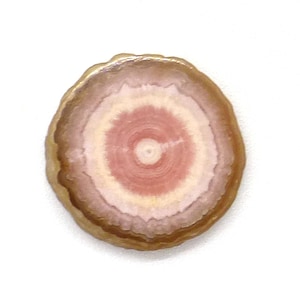 May include: A round, pink and white agate slice with a gold rim. The agate has a concentric pattern of pink and white bands.