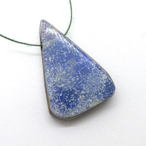 May include: A blue and white opal pendant with a triangular shape. The pendant is strung on a green cord.