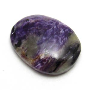 May include: A smooth, oval-shaped purple and grey gemstone with swirls and streaks of color.