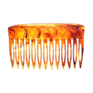 May include: A tortoiseshell-style hair comb with a curved top and evenly spaced teeth. The comb features a marbled pattern of amber and dark brown hues, creating a vintage aesthetic. The teeth are pointed and designed for styling hair.