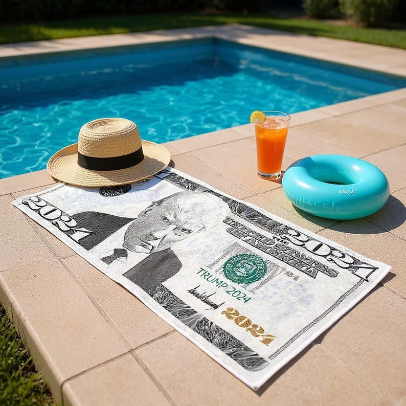 May include: A beach scene with a straw hat, a turquoise inflatable ring, and a cocktail with a lemon wedge. A white beach towel with a black and white image of a dollar bill with the text "TRUMP 2024" is also present.