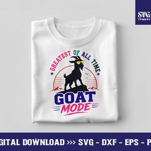 May include: White t-shirt with a graphic featuring a black goat wearing sunglasses, the text "GOAT MODE," and the phrase "GREATEST OF ALL TIME." The design includes a sunset and mountain silhouette.
