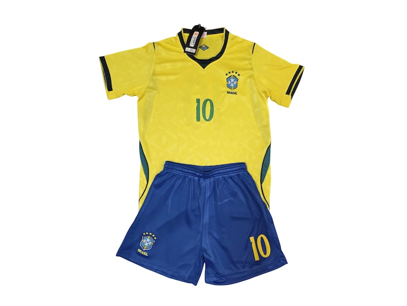 May include: A yellow and blue soccer uniform set. The jersey is yellow with green and black accents, the number 10, and a team emblem. The shorts are blue with the number 10 and a team emblem.