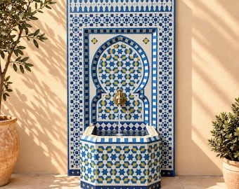 May include: A wall-mounted fountain featuring intricate blue, white, and yellow geometric tile patterns. The structure includes a central arched panel with a brass spigot dispensing a thin stream of water into an octagonal basin below.