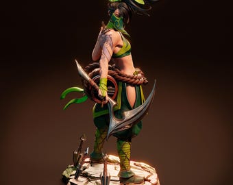 May include: A green and black figurine of a female warrior with a green mask, holding a curved blade and a green and brown shield. The figurine is standing on a rocky base with several small blades scattered around it.