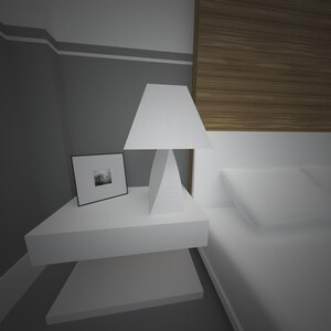 May include: A modern bedroom scene featuring a white bedside table with a geometric lamp and a framed picture. The bed has white bedding. The wall is painted gray with a white trim and a wooden headboard.