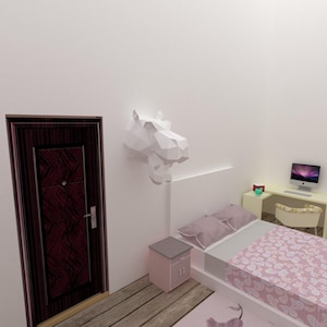 May include: A bedroom interior featuring a white bed with a pink floral patterned comforter and pillows. A white desk with a computer and chair is in the corner. A geometric white animal head decorates the wall.