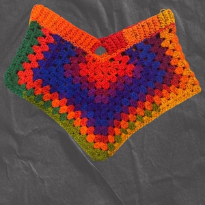May include: A colorful crocheted top with a rainbow pattern. The top is made of a variety of colors, including red, orange, yellow, green, blue, indigo, and violet.