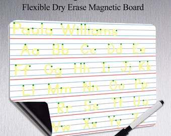 May include: A white, flexible, magnetic letter tracing board for kids with the text "Letter Tracing Board for Kids" and "Flexible Dry Erase Magnetic Board". The board has blue and red lines with yellow letters. A black and white marker is included.