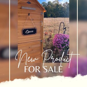 May include: A wooden structure with a sign that says "Open" hanging on the door. The structure is labeled "New Product For Sale" and is described as a "Honour System Bakery".